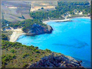 Panoramic view of La Vall, Cala Algaiarens, where the two beaches, the course of the torrent water, the dune area behind Algaiarens, and the crop fields can be seen